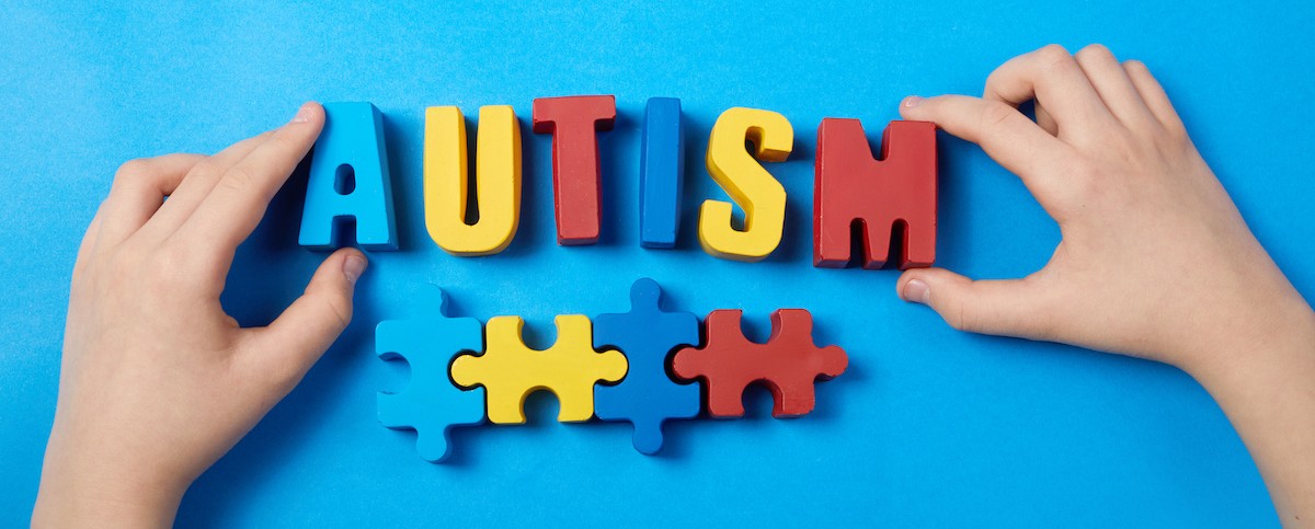 Autistic kid hands holding puzzle jigsaw and word autism, mental health concept. Autism spectrum, disorder. World autism awareness day. Autistic kid hands holding puzzle jigsaw and word autism, mental health concept. Autism spectrum, disorder. World autism awareness day.